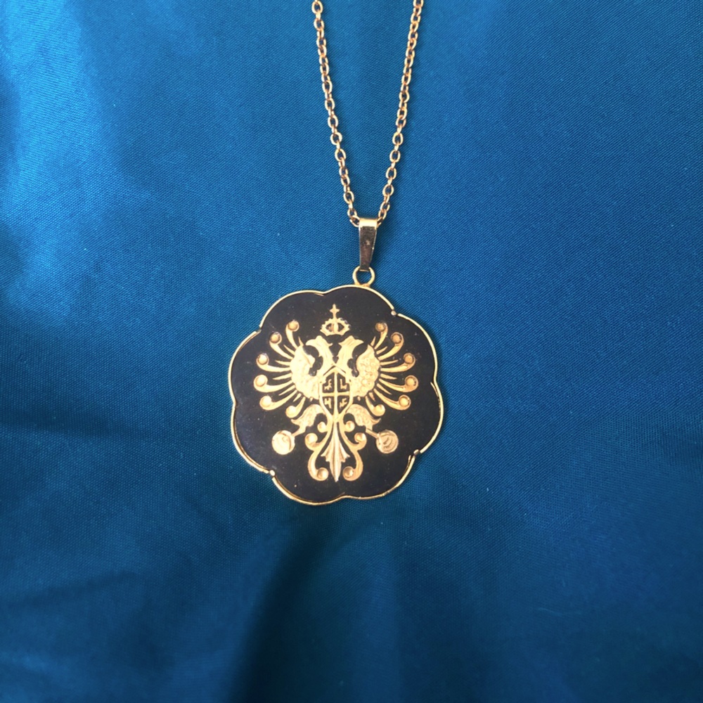 Black and gold family crest looking design.